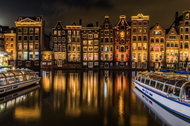 Mike Carroll | The Crooked Houses in Damrak, Amsterdam, at night